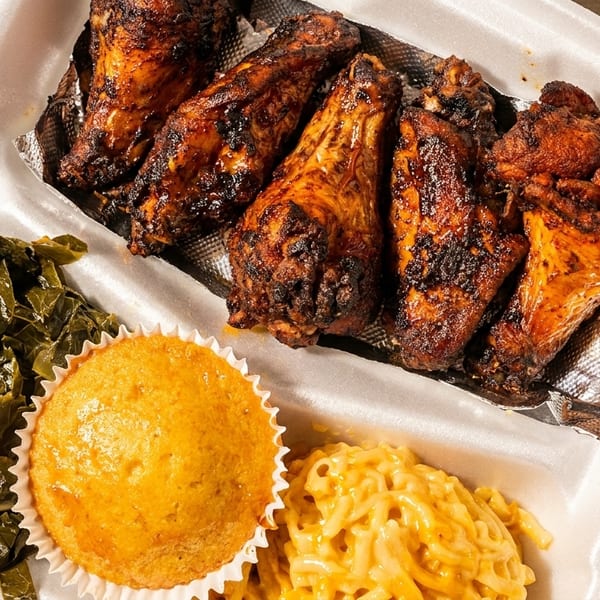 Grilled chicken wings with collard greens, cornbread, and mac & cheese